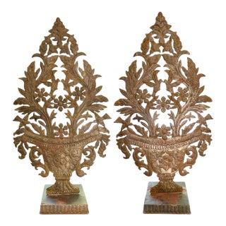A Pair of Metal Repoussé Urn Form Garnitures on Stands For Sale