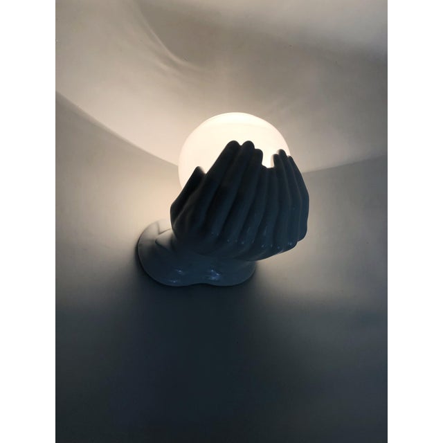 1970s Ceramic Hands Wall Sconce Beautiful wall sconce depicting a pair of hands holding a white globe. In perfect...