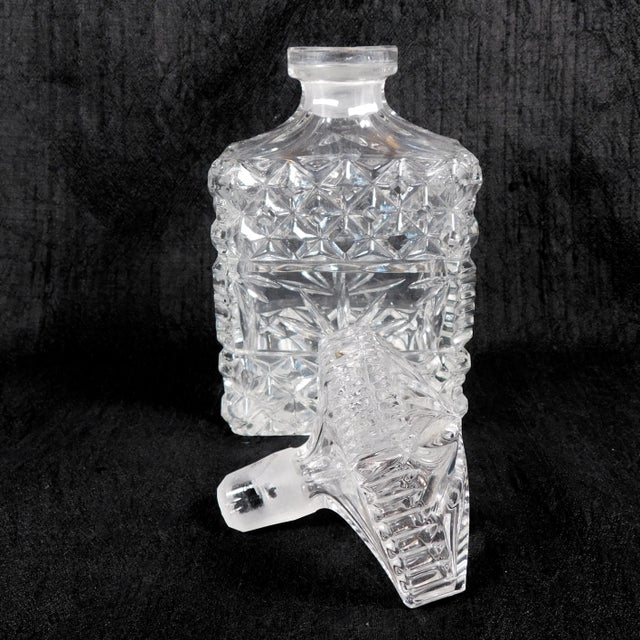 This is cut crystal bottle that can be either a large perfume bottle or a small decanter. It is rectangular in shape with...