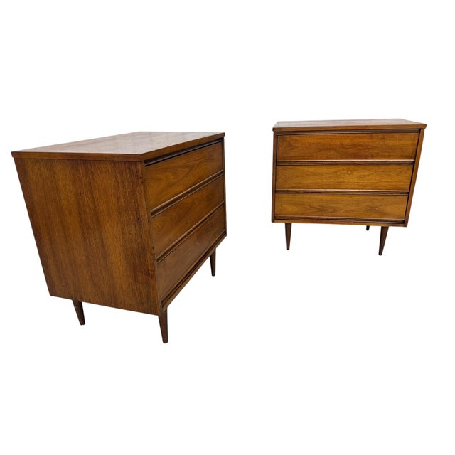 Elevate your bedroom with this striking pair of Mid-Century Modern walnut bachelor chests, beautifully refinished to...