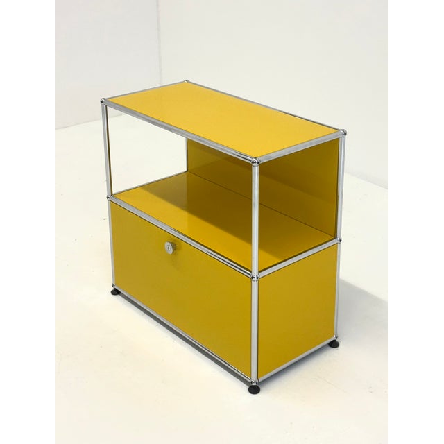 Modular USM Haller cabinet in yellow. This iconic system furniture is constructed of metal panels and a chrome-plated...