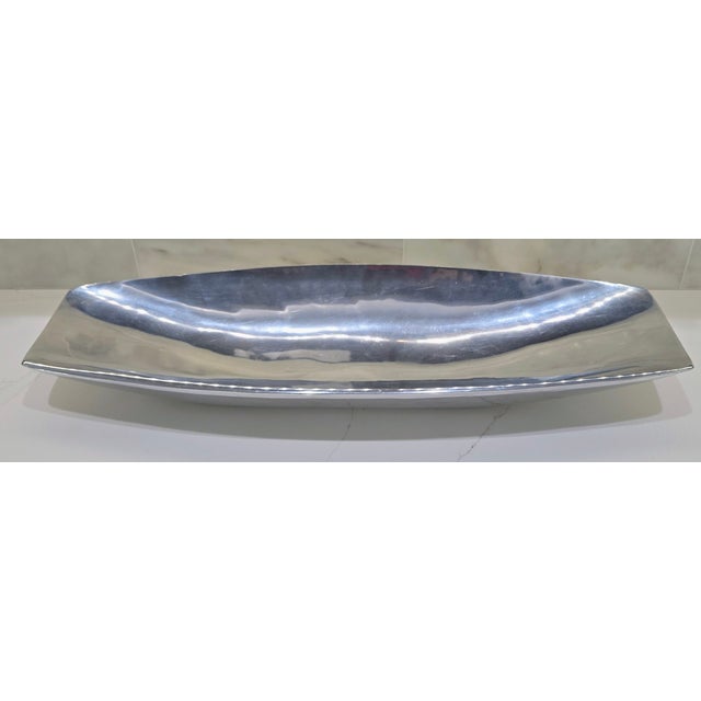 A striking extra-long Nambé Grande Marupa Bowl, model 733, dated 2003 and marked on the underside. Designed in Nambé’s...