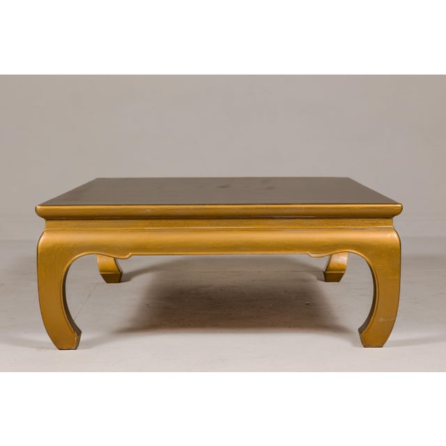 A Ming Dynasty style gold lacquered chow leg coffee table with carved apron. This vintage Ming Dynasty style coffee table,...