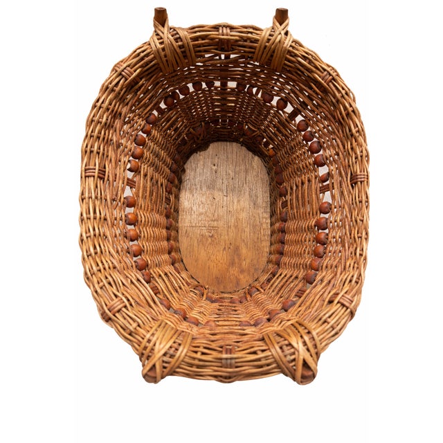 A beautifully textured vintage wicker basket dating to the 1970s, featuring warm honey-toned woven reed and distinctive...