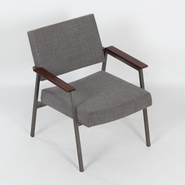 Vintage avanti armchair from the 1960s with teak armrests. The compact armchair has an elegant, open form and has been...