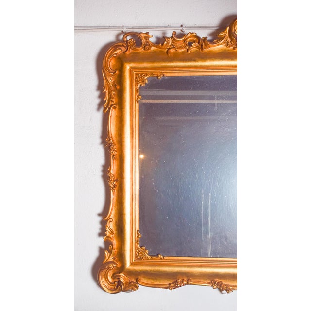 This magnificent mirror features an ornate giltwood frame, richly carved in the Rococo style. Its rectangular shape is...