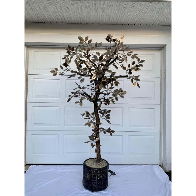 Mid-Century Modern metal tree sculpture by Curtis Jere. This tall dimensional floor tree features torched gold brass metal...