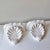 Vintage pair of Hollywood regency style clamshell plaster wall brackets.