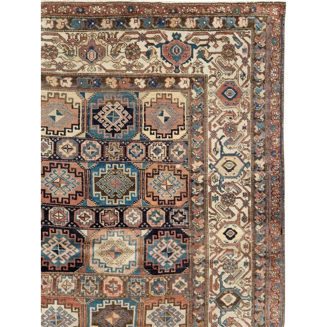 This early 20th-century Persian Northwest room-size carpet presents a richly structured allover geometric composition...
