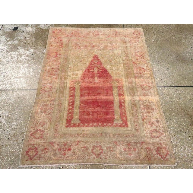 This early 20th century Turkish Sivas rug, measuring 3' 5" x 4' 9", features a classic prayer rug format distinguished by...