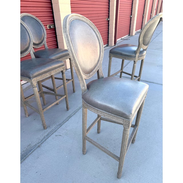 Pair of Restoration Hardware French Contemporary Round Leather Bar Stool Features a round back and angled back legs Frame...