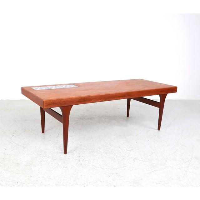 Teak coffee table designed by johannes andersen and produced by cfc silkeborg in the 1960s. coffee table made of teak with...