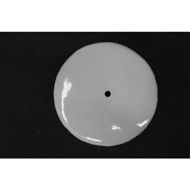 White glazed ceramic garden stool featuring a sculptural leaf motif with openwork detailing throughout. The cylindrical...