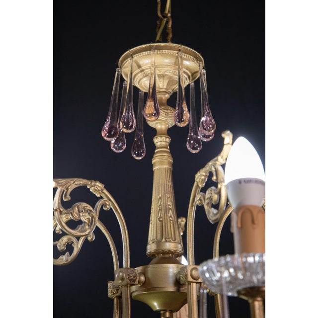 Murano chandelier decorated with precious pink drops. The height with chain measures 100 centimetres, the height without...