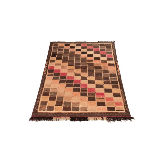 Hand-knotted in wool originating circa 1950-1960, this mid-century Persian rug connotes a vintage Gabbeh rug design of...