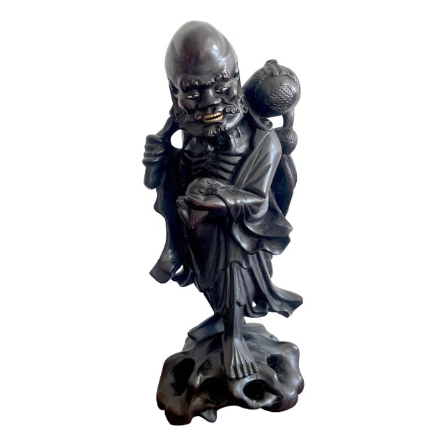 19th Chinese Carved Hardwood Figure of an Immortal Holding a Bat For Sale