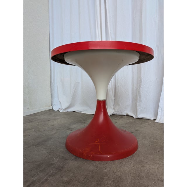 This vintage round pedestal table was produced by Meblo in former Yugoslavia and dates to the 1960s–1970s. It is a classic...