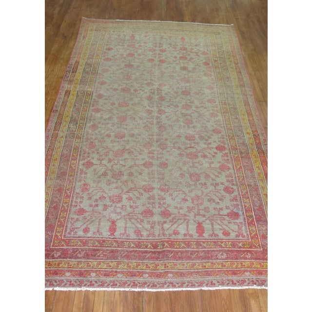 An early 20th century east Turkestan khotan Rug with an all-over pomegranate design on a gray field. Professionally...