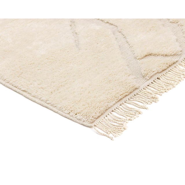 Elegant hand-knotted wool rug with a handwoven abstract pattern in Ivory tones. Ideal for any space seeking a touch of...