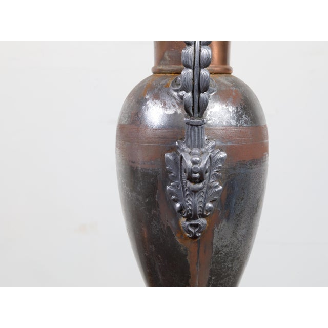 A pair of English tôle amphorae table lamps from the 19th century, with scrolling handles and lucite bases. Created in...