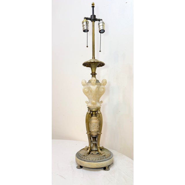 This antique ornate hand-carved figural alabaster and cast iron electric table lamp is a large, beautifully crafted piece...