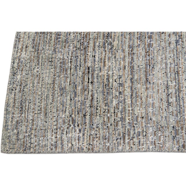 Beautiful contemporary Savannah hand-knotted wool rug with a finely detailed gray color field in an all-over black, brown,...