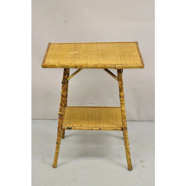 Antique English Victorian Bamboo and Cane 2 Tier Plant Stand Side Table. Circa 1900 Measurements: 25.5" H x 21" W x 15" D.