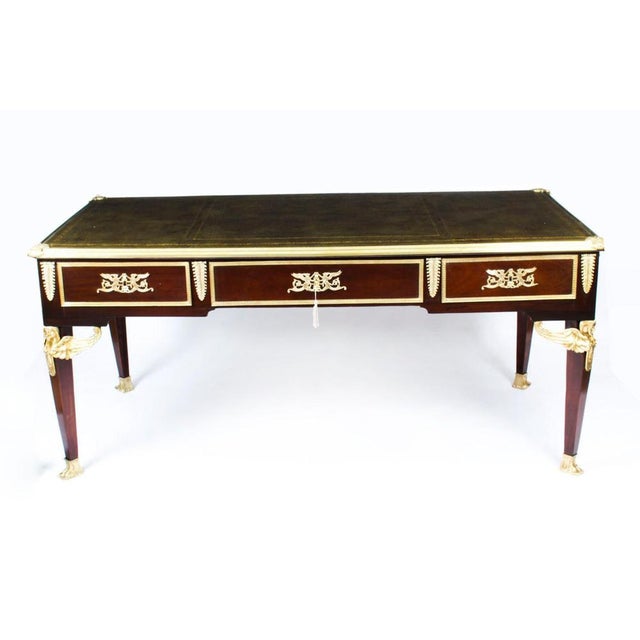 This is a fine antique French Empire ormolu mounted mahogany bureau plat, circa 1870 in date. The rectangular top has an...