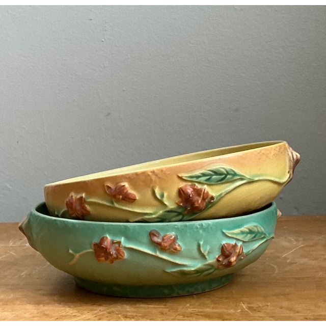 Showcasing the historic legacy of American art pottery, this pair of vintage Roseville pottery bowls from the iconic...