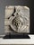 Carved stone fragment on custom black stand. Originating from the 18th century. Pictured is Medusa. Medusa is a figure...
