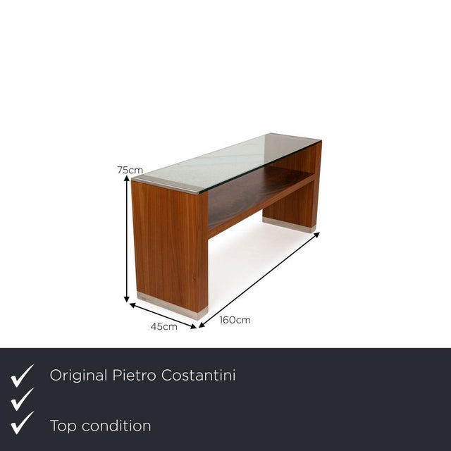 The Constantini sideboard from Petro is made of brown wood and a rectangular glass top. I have official proof of...
