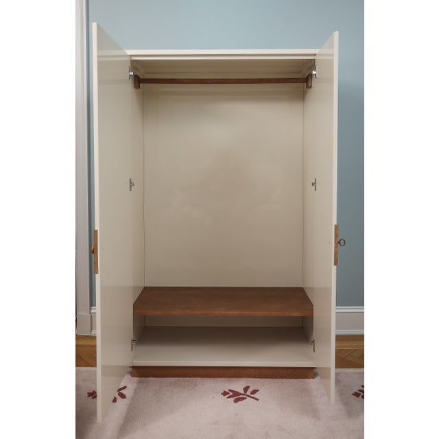 Ivory High Gloss Lacquer Memoire Armoire by Jeremiah Brent for Crate and Barrel. Adjustable shelves and a removable...