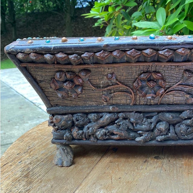 French tramp art jardiniere. Made with pine ones and grapevine. 15”l x 11”w x 8”h 40-001