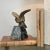 Antique French Bronze Bird Statue on Marble Base features intricate detailing, a gold finish and luxurious dark emerald...