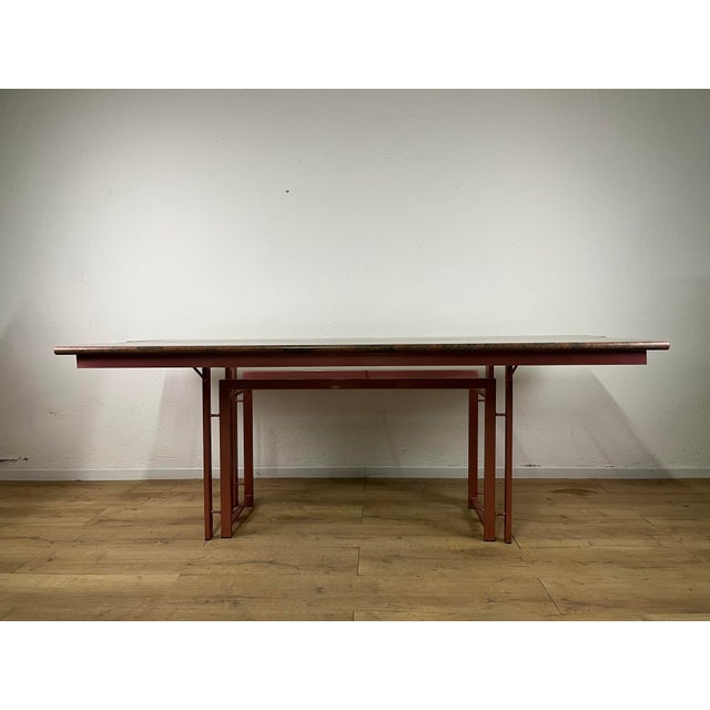 Table with a painted metal base and a granite and glass top, in a postmodern style, made in Italy in the 1970s. The table...