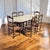 Antique Oval Marble-Top Dining Table With Turned Wood Base. A substantial antique dining table combining a pale oval...