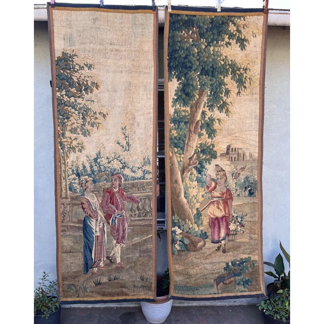 A fine pair of 18th-century tapestries, each measuring approximately 89 x 30½ inches. The first tapestry depicts a...