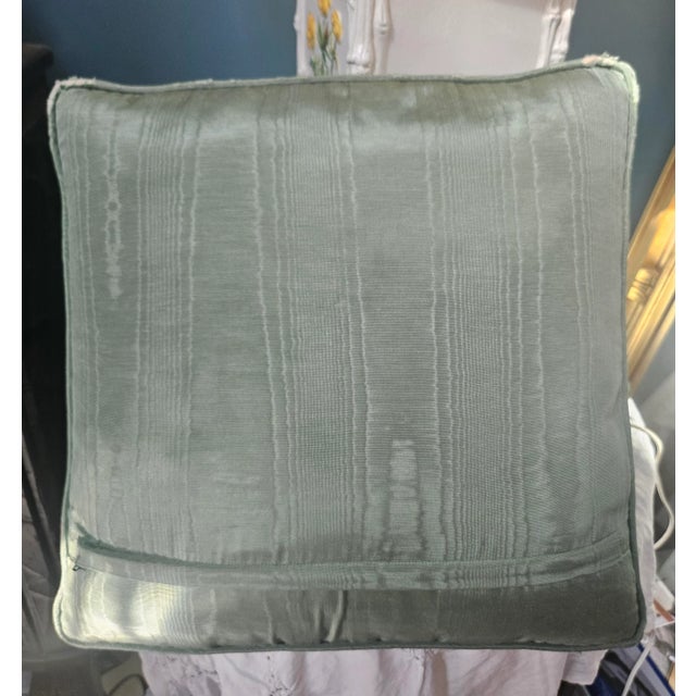 A pillow made from a Barbara Russell needlepoint depicting wildflowers. The needlepoint is set in a beautifully pillow of...