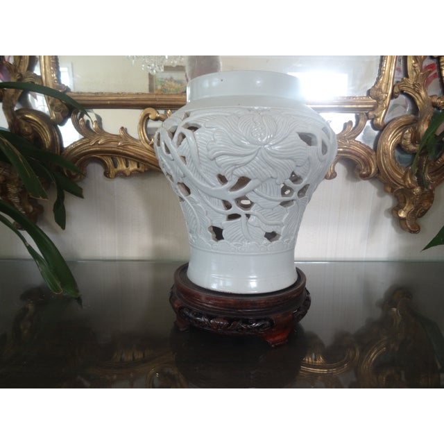 An Unusual Blanc De Chine Reticulated Vase on an antique stand from the late 19th Century. Height without stand 10.5"...