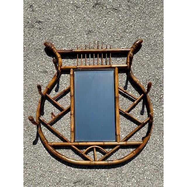 Capture the eclectic charm of this vintage tortoise bamboo hall mirror, a piece that perfectly blends functionality with a...