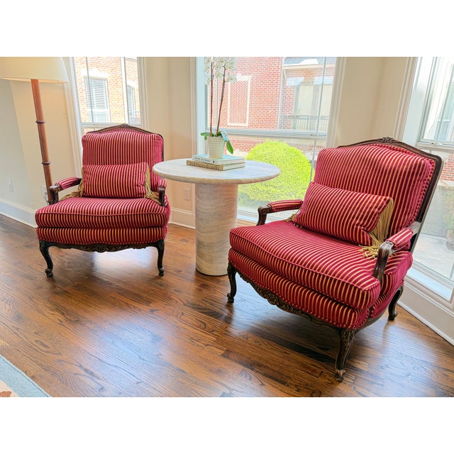 Beautiful pair of red and gold Bergère French velvet arm chairs in great condition. They are extremely well made,...