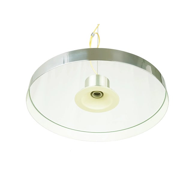 Fine and elegant pendant lamp from the 70s. This lamp was produced in Italy and it is made from aluminum (Canopy and upper...