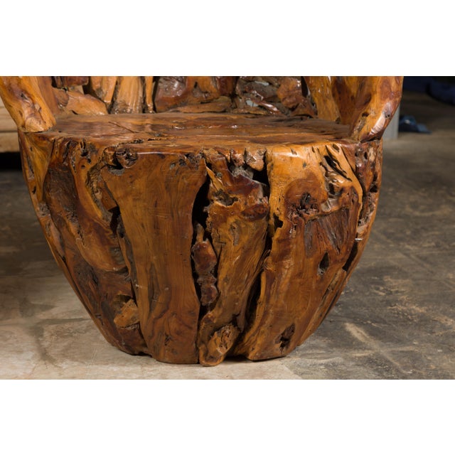 A vintage pair of American root wood armchairs with wraparound backs and rustic character. Experience the raw allure of...