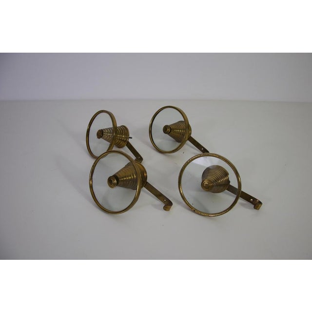 This set of four coat hooks was produced in Italy during the 1960s and showcases the elegant material combinations...