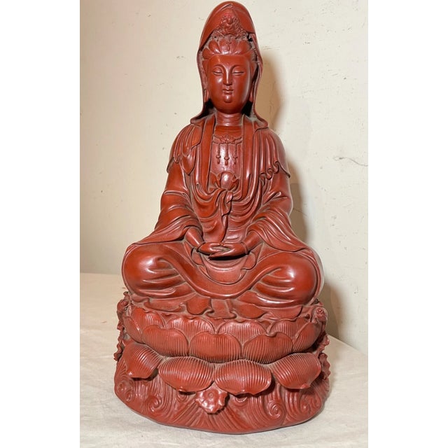 This exquisite sculpture is a fine example of Chinese artistry. Crafted from red lacquer cinnabar, the statue is richly...