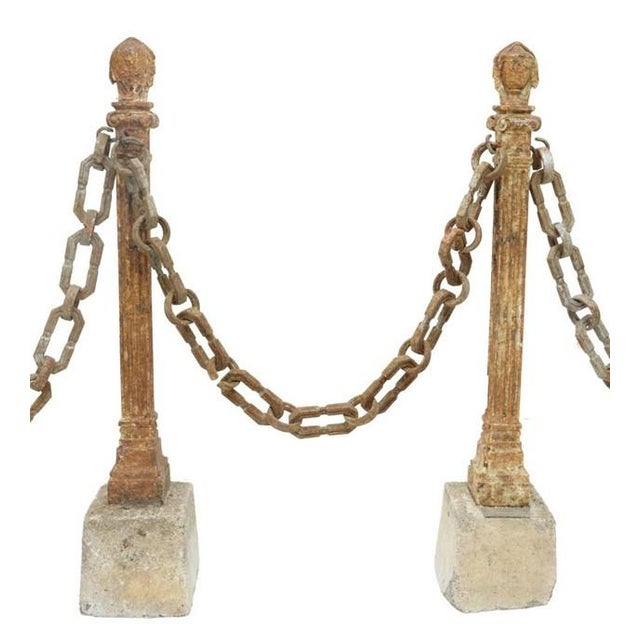 SET OF 4 W/CHAIN. French Neoclassical cast iron stanchions, late 19th/ early 20th c., with urn-form finials, fluted...