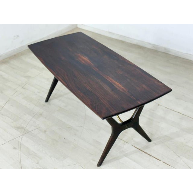 Beautiful vintage coffee table by Karl Erik Ekselius from the 1960s. The elegant design, the exquisite rosewood grain, and...