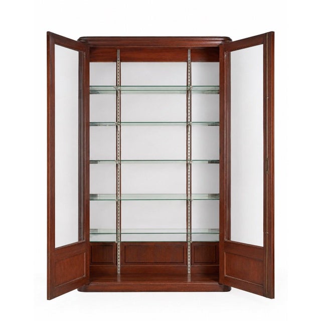 A Belle Époque display cabinet, either for a shop or a collector, crafted from solid oak stained a reddish-brown, dating...