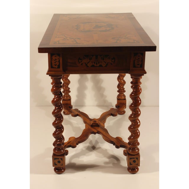 Unique table with exquisite marquetry in cherrywood, kingwood, walnut and elm. The marquetry depicts presentations of...