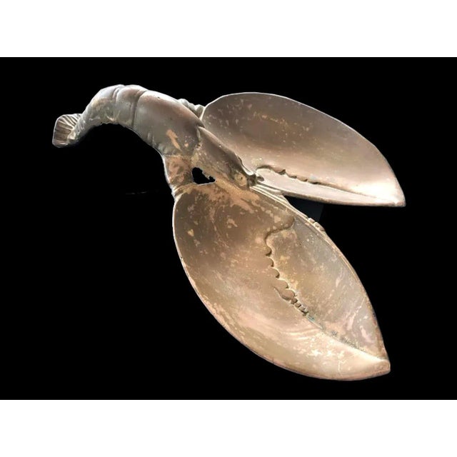 Offered is a whimsical vintage bronze lobster sculpture with the claws shaped as convex bowls, and the body and tail are...